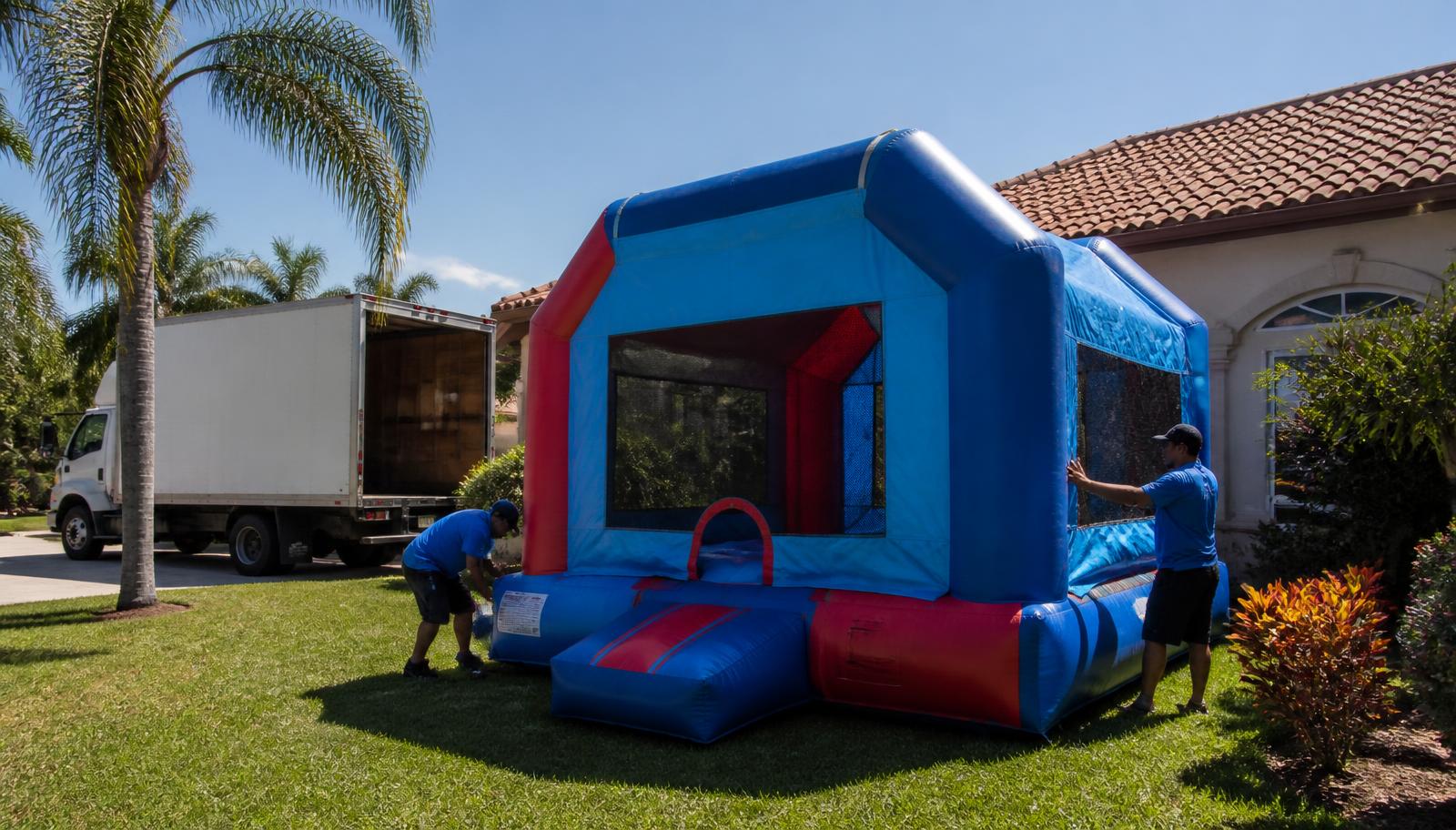 Party rental crew unloading an inflatable from the delivery truck for a Ocoee, FL birthday party