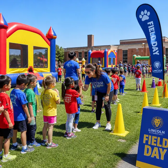 School field day with bounce houses and children